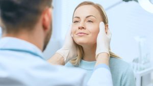 Woman smiles at her doctor during a facelift consultation in Mount Vernon