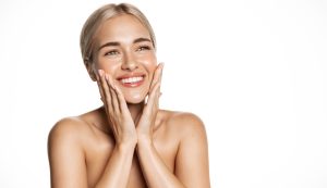 Woman smiling touching her face with nice chin after chin augmentation in Mt Vernon, WA