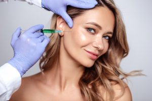 Woman smiling as she gets dermal filler injections in Mount Vernon, WA